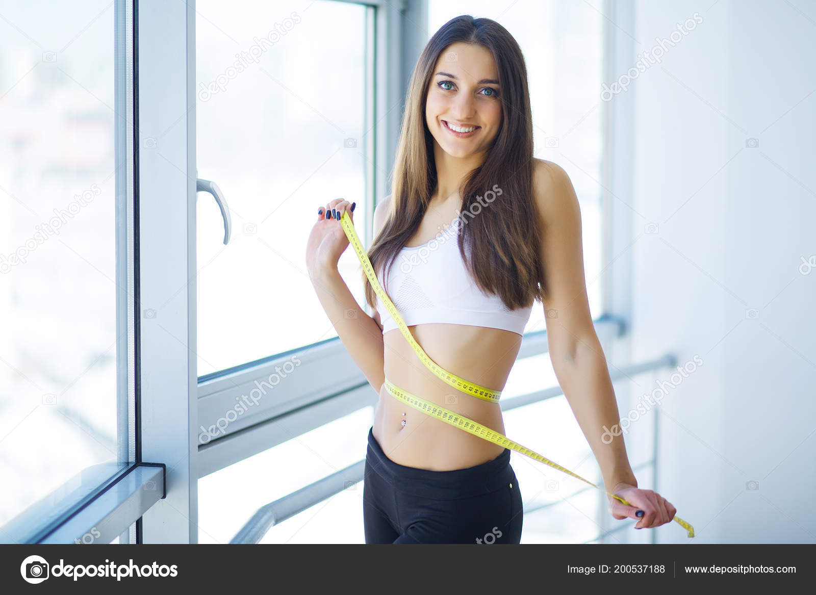 Slim Young Woman Measuring Her Waist Tape Measure Stock Photo by ©Maksymiv  200537188